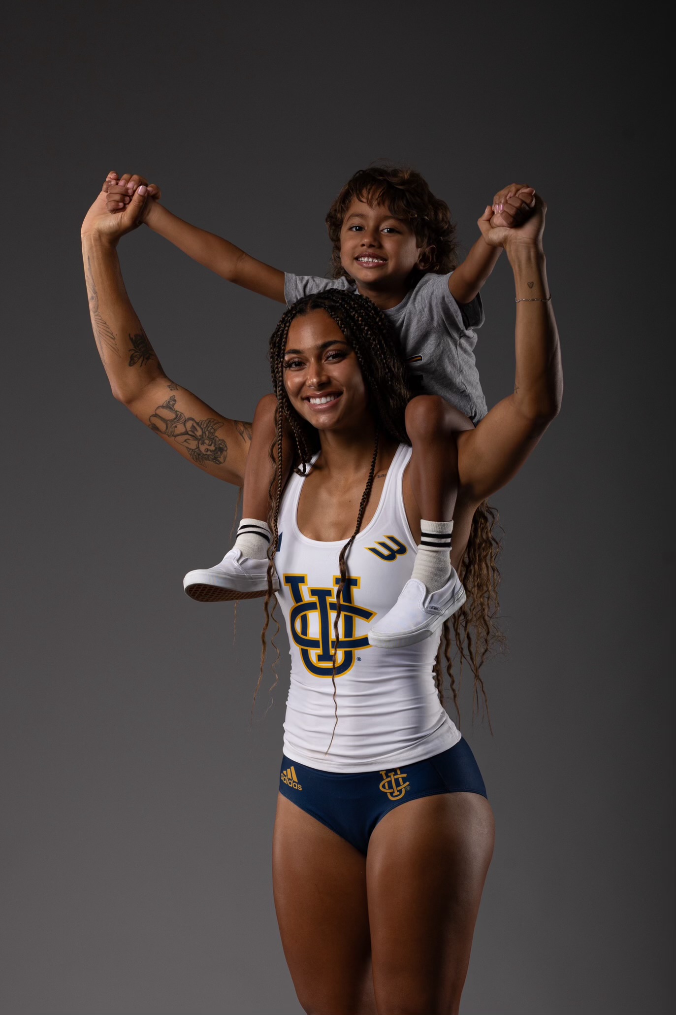 Jolie Robinson with her son on her shoulders in UC Irvine uniform