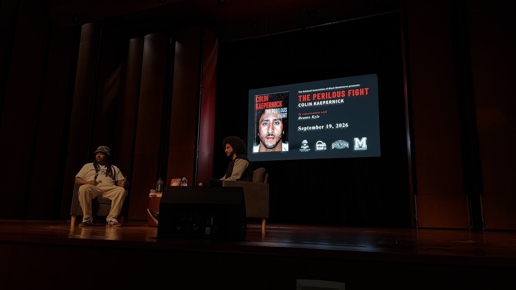 Colin Kaepernick and Deante Kyle onstage at the Ray Charles Performing Arts Center.